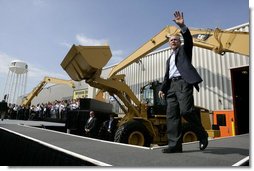 President George W. Bush acknowledges the applause of the crowd as he arrives to sign the Transportation Equity Act, at the Caterpillar facility in Montgomery, Ill., Wednesday, Aug. 10, 2005. White House photo by Eric Draper