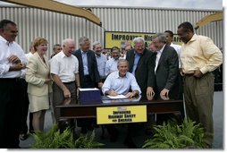 President George W. Bush signs the Transportation Equity Act, at the Caterpillar facility in Montgomery, Ill., Wednesday, Aug. 10, 2005. Joining the President on stage in front row, from left, are Congressman Ray LaHood, R-Ill.; Congresswoman Melissa L. Bean, D-Ill.; Congressman Jim Oberstar, D-Minn.; Congressman Tom Petri, R-Wis.; Senator Kit Bond, R-Mo.; U.S. Transportation Secretary Norman Mineta; Speaker of the House Dennis Hastert, R-Ill.; Congressman Bill Thomas, R-Calif.; and Congressman Bobby Rush, D-Ill. White House photo by Eric Draper