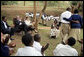 President George W. Bush and Mrs. Laura Bush applaud after a theatrical performance by members of the Lycee de Kigali 'Anti-AIDS Club' Tuesday Feb. 19, 2008, outside of the Lycee de Kigali in Kigali, Rwanda. White House photo by Shealah Craighead