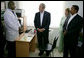 President George W. Bush and Mrs. Laura Bush, joined by Tanzanian President Jakaya Kikwete, visit with a staff doctor Sunday, Feb. 17, 2008, at the Amana District Hospital in Dar es Salaam, Tanzania, where President Bush and Mrs. Bush visited a patients and staff at the hospital's care and treament clinic. White House photo by Chris Greenberg