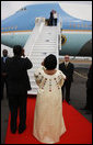 President George W. Bush and Mrs. Laura Bush wave to President Boni Yayi of Benin and Madame Chantal de Souza Yayi as they board Air Force One Saturday, Feb. 16, 2008, after visiting the African country on the first leg of their five-country trip. The President and Mrs. Bush later arrived in Tanzania, where they will spend two days. White House photo by Eric Draper