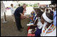 President George W. Bush, joined by Mrs. Laura Bush, greets guests, students and their families during a welcome program Monday, Feb. 18, 2008, to the Maasai Girls School in Arusha, Tanzania. White House photo by Eric Draper