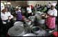 Women work serving dishes of fish, rice and beans at the fish market, Monday, February 18, 2008 in the Tanzanian capitol of Dar es Salaam. White House photo by Chris Greenberg