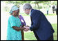 President George W. Bush meets with a family member Sunday, Feb. 17, 2008 at the memorial garden of the U.S. Embassy in Dar es Salaam in Tanzania, during a memorial remembrance for those who died in the 1998 U.S. Embassy bombing. White House photo by Eric Draper