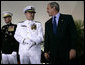 President George W. Bush smiles as he talks with Admiral Thad Allen, Commandant of the U.S. Coast Guard, on stage at Fort Lesley J. McNair in Washington D.C., during a Change of Command Ceremony Thursday, May 25, 2006. White House photo by Eric Draper