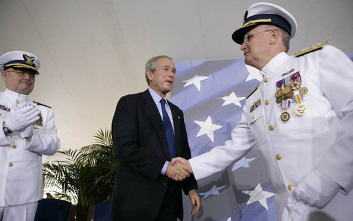 President George W. Bush congratulates Admiral Tom Collins for his 38 years of service in the U.S. Coast Guard, including the last four as Commandant, during the U.S. Coast Guard's Change of Command Ceremony Thursday, May 25, 2006, at Fort Lesley J. McNair in Washington, D.C. Looking on is Admiral Collins' successor, Admiral Thad Allen. White House photo by Eric Draper