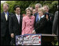 President George W. Bush puts his arms around U.S. Senator Kay Bailey Hutchison (R-Texas) and Ohio Congresswoman Deborah Pryce, right, after signing H.R. 4297, the Tax Relief Extension Reconciliation Act of 2005, during ceremonies Wednesday, May 17, 2006, on the South Lawn of the White House. White House photo by Eric Draper