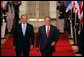 President George W. Bush walks through the Cross Hall with Prime Minister Ehud Olmert of Israel to a joint press conference in the East Room Tuesday, May 23, 2006. White House photo by Kimberlee Hewitt