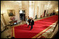 President George W. Bush and Laura Bush walk with Australian Prime Minister John Howard and his wife Mrs. Janette Howard through the Cross Hall as they arrive for the official dinner held in honor of the Prime Minister Tuesday, May 16, 2006. White House photo by Eric Draper