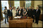 President George W. Bush is joined by Congressman Steve Buyer, R-IN, second from left, Congressman Mike Rogers, R-MI, center background, Senator Bill Frist, R-TN, right, Senator John Warner, R-Va, far right, members of the Patriot Guard Riders and family members of fallen soldier, Sergeant Rickey Jones who was killed in Iraq, as he signs H.R. 5037, the Respect for America's Fallen Heroes Act, Monday, May 29, 2006. White House photo by Paul Morse