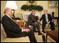 President George W. Bush shakes the hand of Porter Goss Friday, May 5, 2006, in the Oval Office after the Director of the Central Intelligence Agency announced his resignation. The President thanked him for his service and said of Director Goss, "He honors the proud history of the CIA." Looking on is Ambassador John Negroponte, Director of National Intelligence. White House photo by Eric Draper