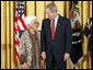 President George W. Bush and Virginia Ganzon-Sturwold of San Francisco exchange glances during the presentation of the President's Volunteer Service Award during a celebration of Asian Pacific American Heritage Month in the East Room Friday, May 12, 2006. White House photo by Paul Morse