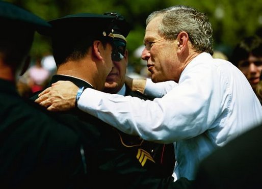 President George W. Bush talks with officers at the Annual Peace Officers' Memorial Service at the U.S. Capitol in Washington, D.C., Saturday, May 15, 2004. "In the Memorial, and in countless acts of love and kindness, the fallen are remembered and honored. And this afternoon, on behalf of all Americans, I offer the respect of a grateful nation," said the President. "Their calling in life was to keep the peace." White House photo by Paul Morse