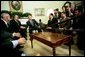 President George W. Bush talks with the press during an Oval Office meeting with several Iraqis who receive medical care in the United States Tuesday, May 25, 2004. "I'm honored to shake the hand of a brave Iraqi citizen who had his hand cut off by Saddam Hussein," said the President. "I'm with six other Iraqi citizens, as well, who suffered the same fate. They are examples of the brutality of the tyrant." White House photo by Eric Draper