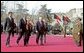 Prior to the inauguration of Afghanistan President Hamid Karzai, Vice President Dick Cheney and his wife, Lynne, and U.S. Ambassador to Afghanistan Zalmay Khalilzad, second on left, attend a welcoming ceremony at the Presidential Palace in Kabul, Afghanistan, Dec. 7, 2004. White House photo by David Bohrer