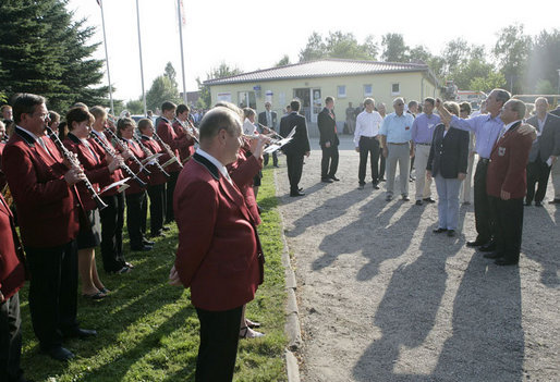 President George W. Bush conducts the Jagdhornblaser Baremerhagen Band after arriving in Trinwillershagen, Germany, for a barbeque dinner courtesy of Chancellor Angela Merkel. White House photo by Eric Draper
