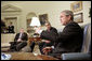 President George W. Bush and Zalmay Khalilzad, U.S. Ambassador to Iraq, meet with the press in the Oval Office Thursday, July 6, 2006. White House photo by Eric Draper