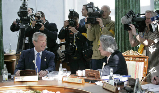 President George W. Bush talks with Japanese Prime Minister Junichiro Koizumi during a working session at the G8 Summit in Strelna, Russia, Sunday, July 16, 2006. White House photo by Eric Draper