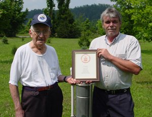 Mr. Gene Peck (left) of Big Fork, Arkansas holds a 10 Year Length-of-Service Award from the National Weather Service. 
