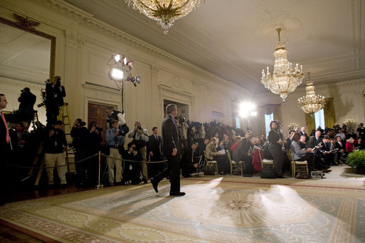 President George W. Bush walks into the East Room for a press conference in Wednesday, Oct. 25, 2006. "Our security at home depends on ensuring that Iraq is an ally in the war on terror and does not become a terrorist haven like Afghanistan under the Taliban," said President Bush. White House photo by Paul Morse