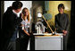 Mrs. Laura Bush watches as David Temple, actor portraying Benjamin Franklin, performs a demonstration related to static electricity at the Houston Museum of Natural Science, Wednesday, October 18, 2006, with the help of a 6th grade student from the Baines Middle School in Houston, TX. White House photo by Shealah Craighead