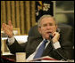 President George W. Bush gestures as he speaks with Iraq's Prime Minister Nouri al-Maliki during a telephone conversation Monday, Oct. 16, 2006, in the Oval Office. White House photo by Eric Draper