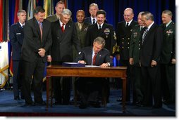 President George W. Bush signs the Bob Stump National Defense Authorization Act at the Pentagon Monday, Dec 2. "The legislation I sign this afternoon was passed by Congress in a remarkable spirit of unity. It sets priorities of our Defense Department in a critical, critical period for our country," said President Bush."We're rewarding the service and sacrifice of our military families with higher pay, improved facilities and better housing."  White House photo by Paul Morse