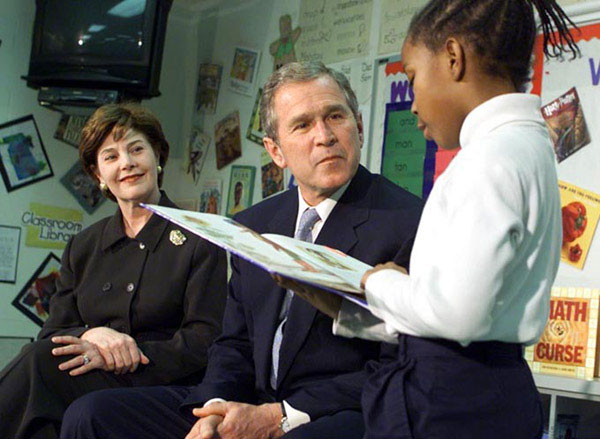 President George W. Bush and the First Lady Laura Bush listen to student Janea Bufford read at Moline Elementary School in St.Louis, Missouri on February 20 2001. White House Photo by Paul Morse.