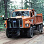 Alger County Road Commission trucks grades a gravel road.