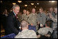 President George W. Bush is greeted by military personnel following his address on the global war on terror at the Military Officers Association of America meeting Tuesday, Sept. 5, 2006, at the Capital Hilton Hotel in Washington. President Bush spoke about the U.S. and allies strategy for combating terrorism saying "we're confronting them before they gain the capacity to inflict unspeakable damage on the world, and we're confronting their hateful ideology before it fully takes root." White House photo by Kimberlee Hewitt