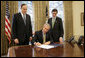 President George W. Bush signs S. 3850, The Credit Rating Agency Reform Act of 2006, in the Oval Office Friday, Sept. 29, 2006. Standing with President Bush are bill sponsors Senator Richard Shelby, R-Ala., left, and Representative Mike Fitzpatrick, R-Pa. The legislation removes the Securities and Exchange Commission from the process of approving certain rating agencies as nationally recognized statistical rating organizations. White House photo by Eric Draper