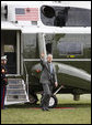 President George W. Bush waves to Mrs. Laura Bush and her Midland High School graduating classmates of 1964 welcoming his return to the South Lawn of the White House Friday afternoon, March 28, 2008. Mrs. Bush is hosting her classmates for their class reunion at the White House. White House photo by Eric Draper