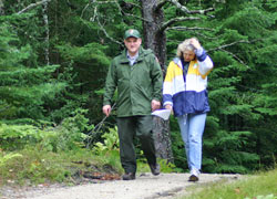 The Lakeshore's Biologist/Forester walking with a park visitor.