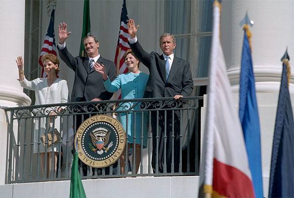 Waving from the White House balcony, President Bush welcomes Mexican President Vicente Fox during the President's First State Visit Sept. 6. White House Photo by David Bohrer.