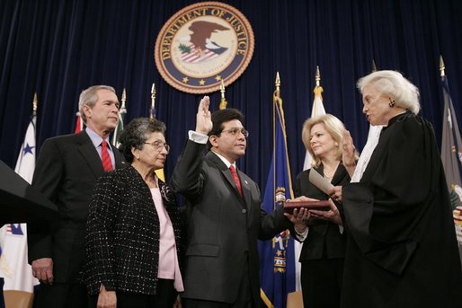 Justice Sandra Day O'Connor offers Alberto Gonzales the oath of office Monday, Feb. 14, 2005, during his ceremonial swearing-in at the Justice Department. With President George W. Bush looking on are Mr. Gonzales's mother, Maria, and wife, Becky. White House photo by Paul Morse.