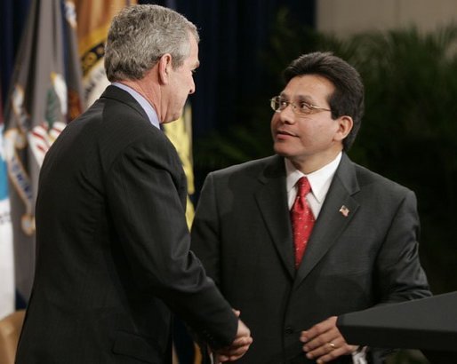 Attorney General Alberto Gonzales receives congratulations from President Bush during ceremonies Monday, Feb. 14, 2005, marking Mr. Gonzales's new post. White House photo by Paul Morse.