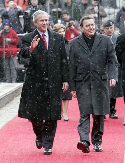 President George W. Bush and German Chancellor Gerhard Schroeder wave to the crowd during an official arrival ceremony at the Electoral Palace in Mainz, Germany, Wednesday, Feb. 23, 2005. White House photo by Eric Draper