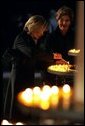 Laura Bush and Mrs. Schroeder-Koepf light candles during a tour of Saint Martin's Cathedral in Mainz, Germany, Feb. 23, 2005. White House photo by Susan Sterner