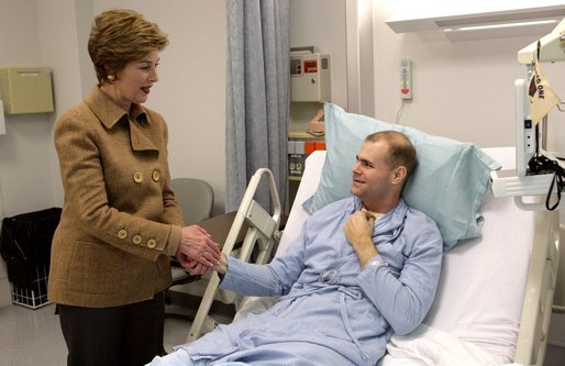 Laura Bush visits with U.S. Army Specialist Garrett Larson who is recovering from injuries sustained in Iraq at the Landstuhl Regional Medical Center Tuesday, Feb. 22, 2005, in Ramstein, Germany. White House photo by Susan Sterner