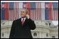 President George Bush listens to Slovak Prime Minister Mikulas Dzurinda's introduction before giving remarks at Hviezdoslavovo Square in Bratislava, Slovakia, Feb. 24, 2005. White House photo by Eric Draper