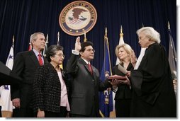 Justice Sandra Day O'Connor offers Alberto Gonzales the oath of office Monday, Feb. 14, 2005, during his ceremonial swearing-in at the Justice Department. With President George W. Bush looking on are Mr. Gonzales's mother, Maria, and wife, Becky.  White House photo by Paul Morse