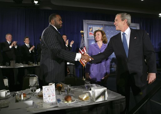 President George W. Bush greets Detroit Mayor Kwame Kilpatrick after delivering remarks at the Detroit Economic Club in Detroit, Michigan, Tuesday, Feb. 8, 2005. Also pictured at center is Detroit Economic Club President Beth Chappell. White House photo by Eric Draper