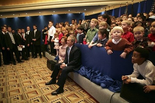 President George W. Bush and Laura Bush sit with children of embassy staff during their visit with U.S. Embassy employees Monday, Feb. 21, 2005, at the Sheraton Brussels Hotel and Towers in Brussels. White House photo by Eric Draper