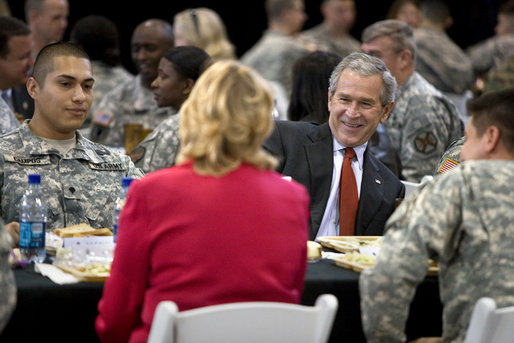 President George W. Bush talks with U.S. troops and their families over lunch during his visit to Fort Benning, Ga., Thursday, Jan. 11, 2007. White House photo by Eric Draper