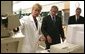 President George W. Bush and FBI Director Robert Mueller watch as chemist Eileen Waninger, left, demonstrates a TSQ - 1 ThermoFinnigan Triple Stage Quadruple GC/MS instrument during a tour of the new FBI Laboratory in Quantico, Va., Wednesday, Sept. 10, 2003. The TSQ-1 has been used to identify chemical components for the Embassy bombings in Africa, attack on USS Cole and the bombing of United Nations in Iraq. White House photo by Paul Morse