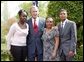 President George W. Bush congratulates the Groundwork Providence Environmental Team of Providence, R.I., on receiving the President's Environmental Youth Award in the East Garden April 22, 2004. Members of the team include, from left to right, Olabisi Davies, 17, Taja Gonsalves, 15, and Miguel Blanco, 16.