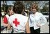Laura Bush speaks with American Red Cross Disaster Relief workers at the Vero Beach Community Center where disaster relief is offered to local residents Oct. 1, 2004. Vero Beach, Fla., was one of the areas hardest hit by Hurricanes Jeanne and Frances. "See, these volunteers show the true heart of America, because we're a compassionate people, we care when a neighbor hurts, we long to help somebody when help is needed," said President Bush during a visit with volunteers in Stuart, Fla., Sept. 30. "They have the gratitude of all they've served, and they have the admiration for our whole country."