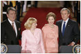 President George W. Bush and Ukraine President Viktor Yushchenko are joined at the podiums by first ladies Laura Bush and Kateryna Yushchenko Monday, April 4, 2005, in the East Room of the White House.