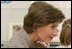 Mrs. Laura Bush receives a farewell hug from a young child at a Boys & Girls Club program Thursday, Feb. 22, 2007 at the D’Iberville Elementary School in D’Iberville, Miss. White House photo by Shealah Craighead 