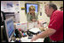 First Lady Laura Bush gets an update on the situation of efforts to help people in the aftermath of hurricane Katrina during a visit of Red Cross headquarters with President George W. Bush on Sunday September 4, 2005.